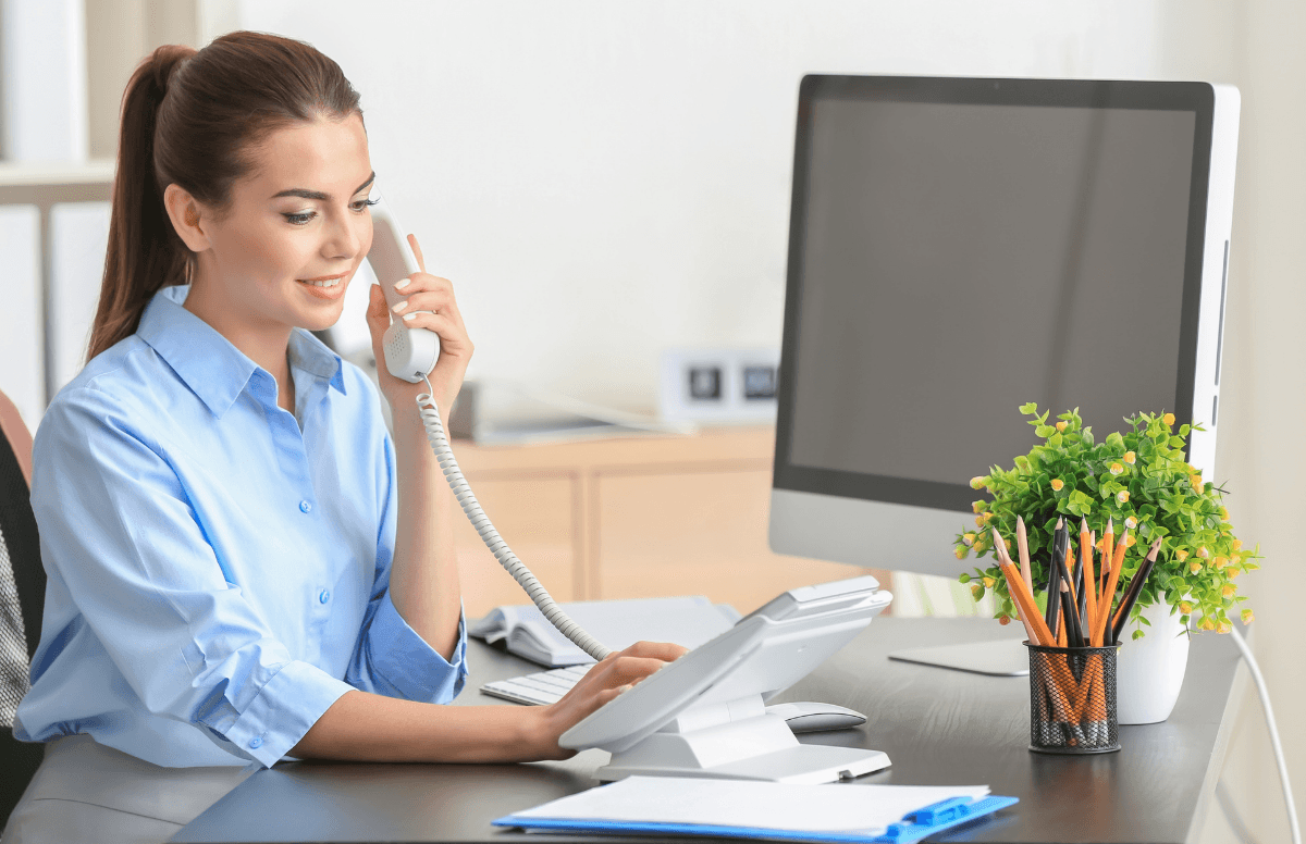 Staff member answering a phone at a desk