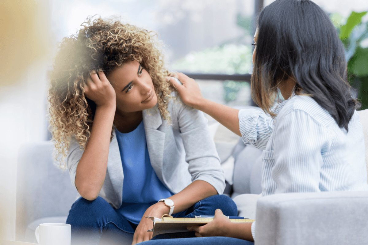 Therapist offering support to a client during a counseling session